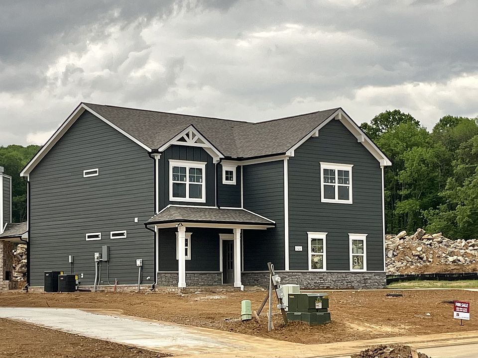 Wonderful home in dark grey Hardie Siding with stone accents. This is the actual home In Brewer Poi