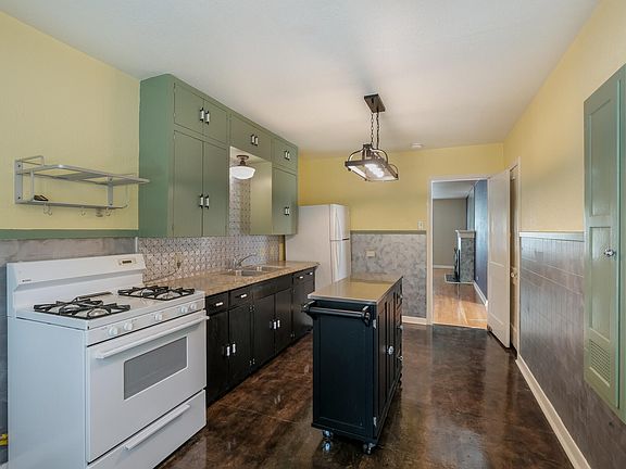 Oversized eat-in kitchen has plenty of room to hang out, prepare meals, and still stay in the middle of all the action