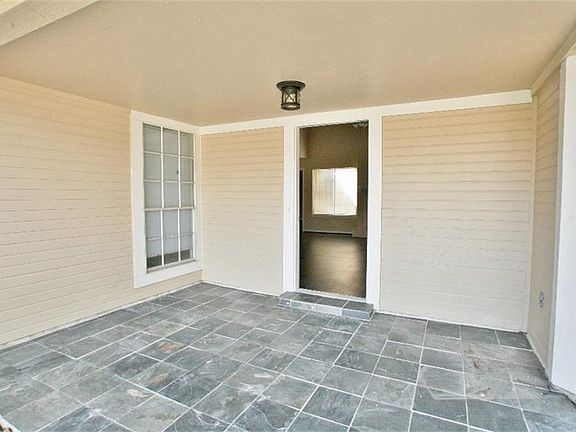 Welcome guests in the large sheltered slate paved porch