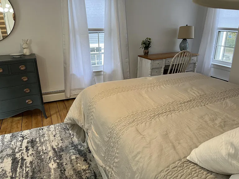 Bedroom showing dresser and desk areas.
