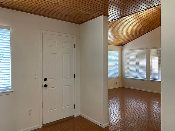 Entry hall. Beautiful vaulted wood ceilings and tile floors.