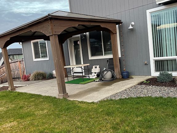 Backyard has patio with gazebo.