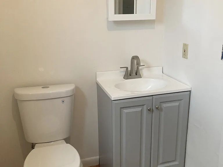 brand new toilet, cabinet, fixtures and new paint, flooring and tile in bathroom
