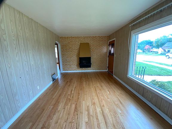 Living room. (refinished hardwood floors; large windows that allows for lots of natural light.)