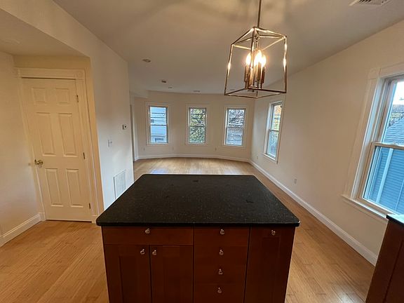 View from Kitchen into Living room. Beautiful natural light. Alcove is hidden off to the left.