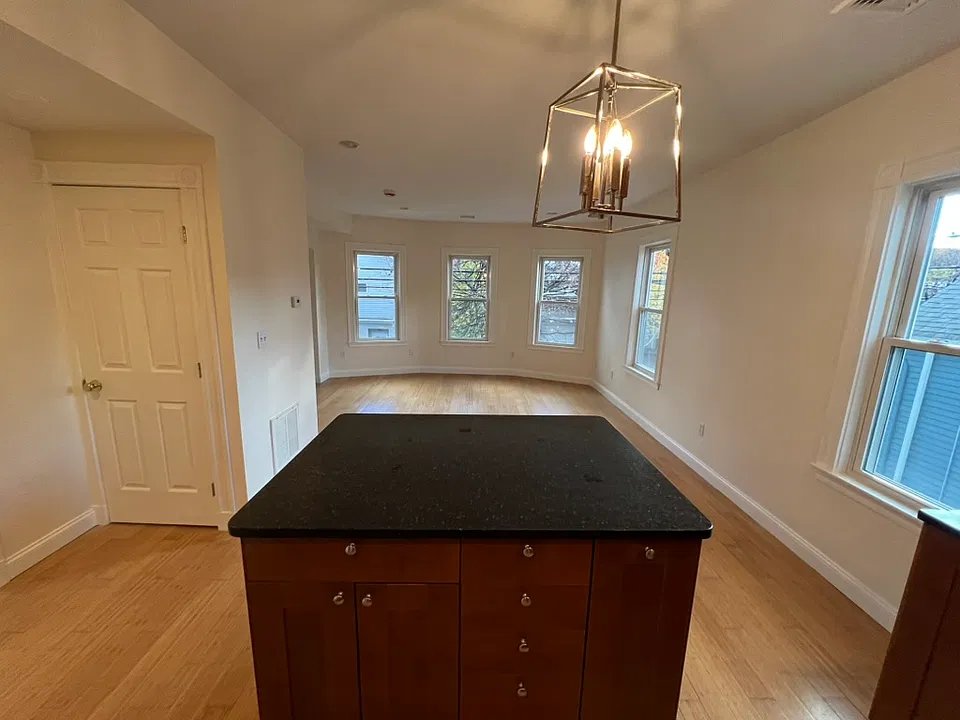 View from Kitchen into Living room. Beautiful natural light. Alcove is hidden off to the left.