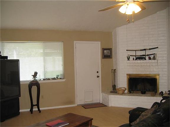 Den with Vaulted Ceiling and Fire Place