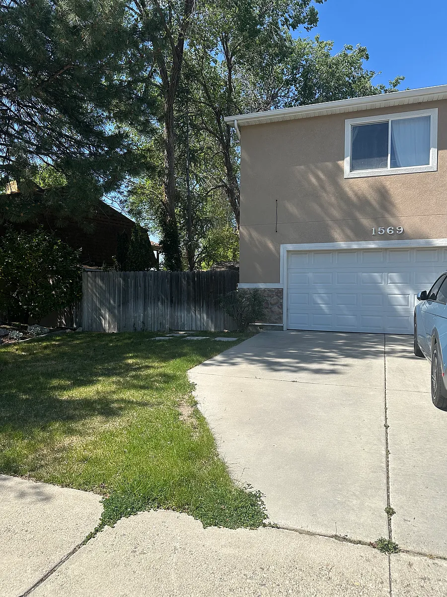 Enter through the gate to the back door entrance. - 1569 E 8560 S