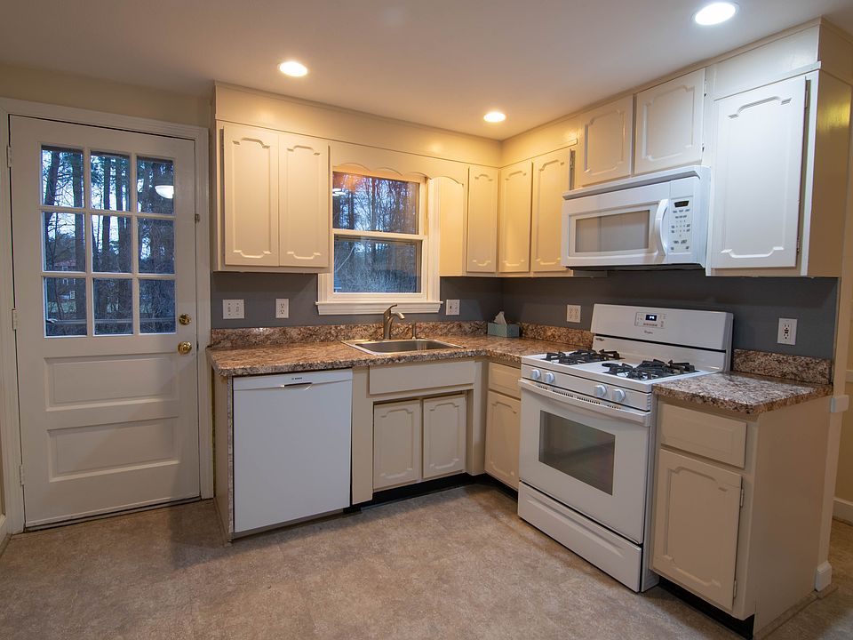 Fully applianced kitchen in back of house with walkout stairs.
