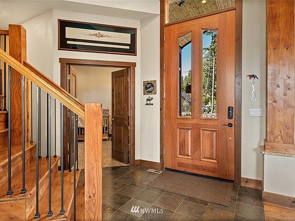 Beautiful & practical slate floors & oversized front door just lead to an elegant, luxurious front entry!