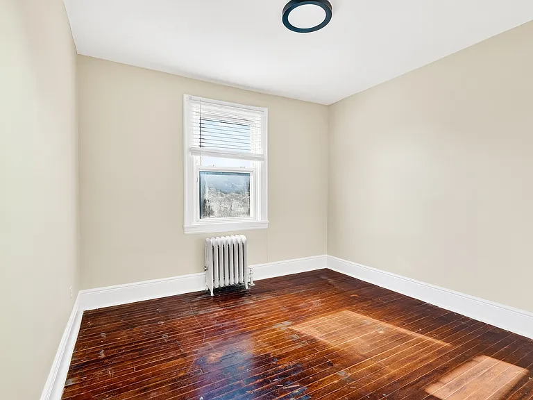 Bedroom with hardwood floors.