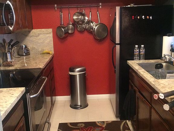 granite counters, electric stove, stainless steel