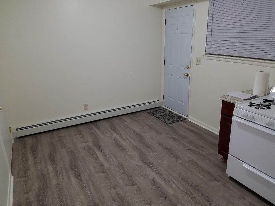 Kitchen entrance - new vinyl flooring, new countertop, new oven, new pantry doors, new baseboard covers