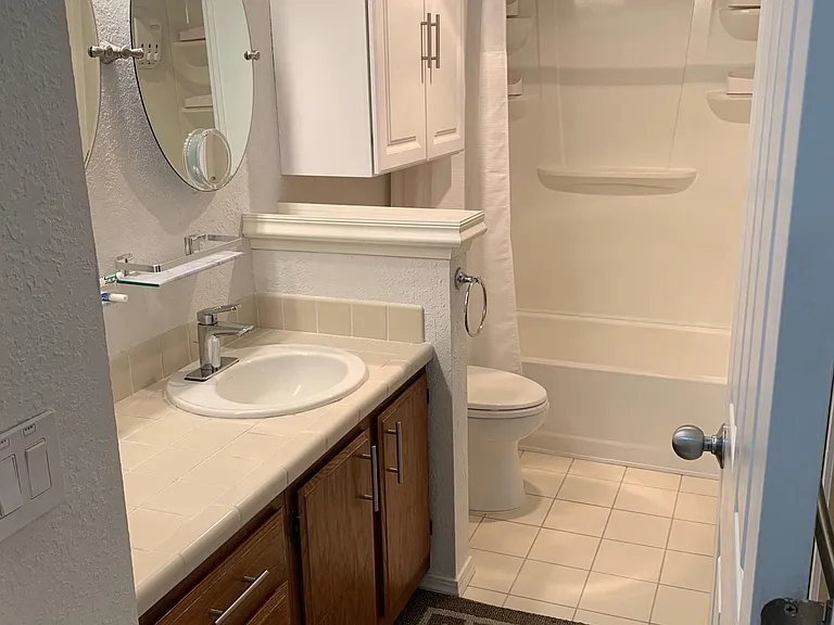 Tub with 5-extra storage units on walls, toto self closing toilet lid, build-ins under sink, multiple towel racks and door command hooks. Slider door leads to master bedroom. Newly restored tile counter and floor. New addition cabinet with organizer in b