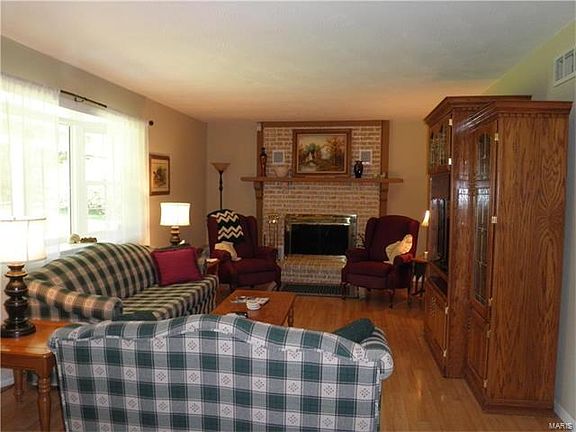 Living Room w/ wood burning fireplace, bay window