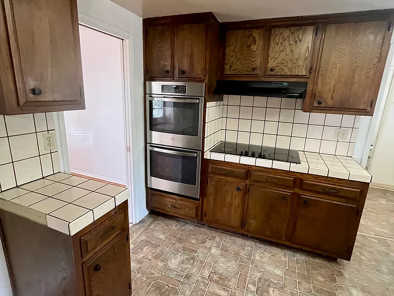 A spacious kitchen with ample storage.