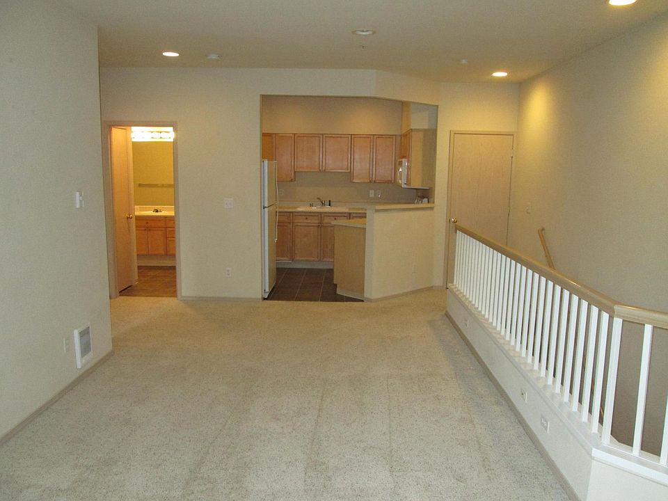 Living room into the kitchen. Bathroom and bedroom are to the left, washer/dryer behind the door on the right.