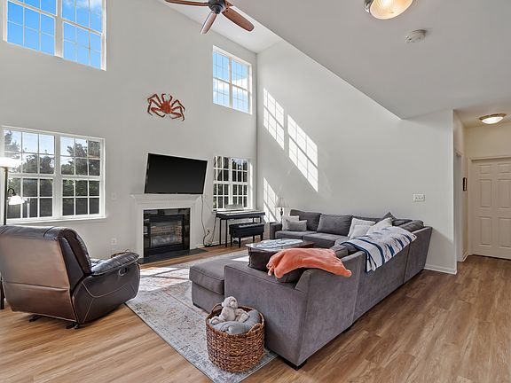 Open concept kitchen to living room with beautiful vaulted, two-story ceilings. Breathtaking private, backyard views with ample natural light.