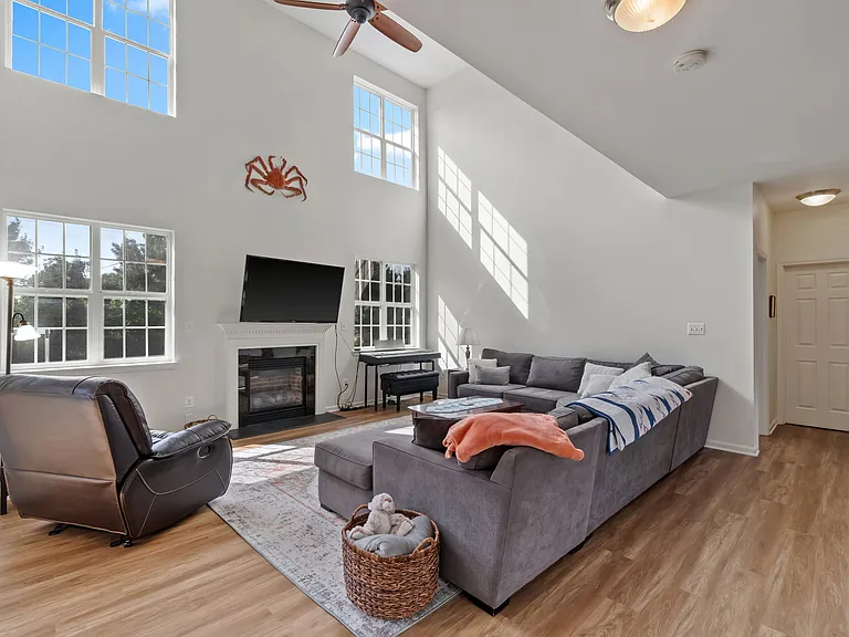 Open concept kitchen to living room with beautiful vaulted, two-story ceilings. Breathtaking private, backyard views with ample natural light.