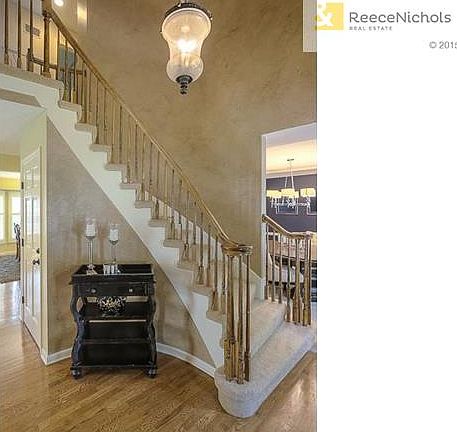 Grand two story entry with curved staircase.