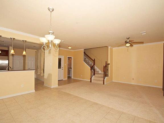Inviting living room with beautiful drapes, wrought iron spi
