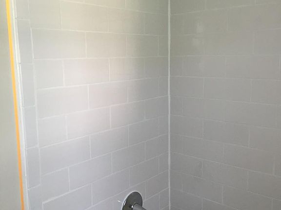 Bathroom 2 of 2 (White Subway tile surround)