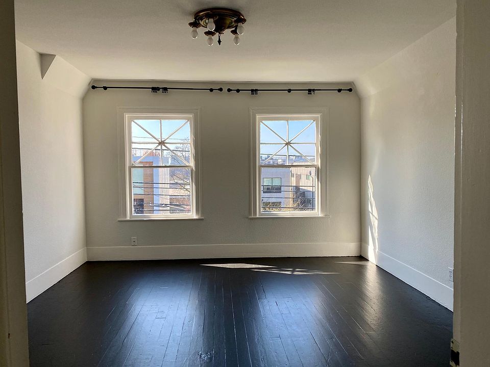 This large living room has views of the Space Needle, the Olympic Mountains and lovely sunsets