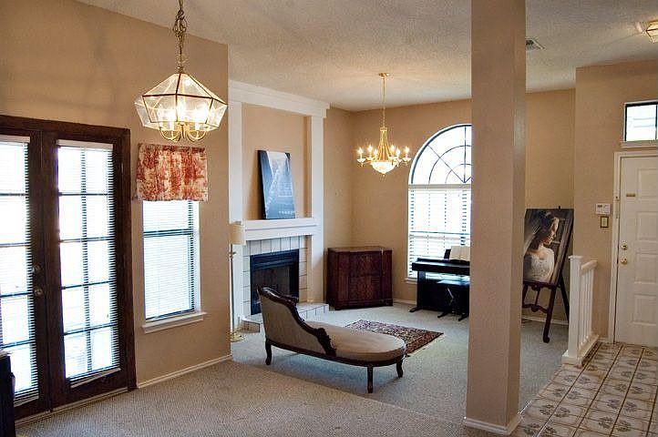 Entry with beautiful tile, step down formal LR w/fireplace, DR w/french doors