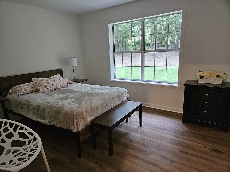 Bedroom with Queen sized bed and large closet with window which may double as a home office.