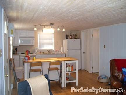 NEWLY REMODELED KITCHEN
						:
						Refrigerator, stove/oven, microwave, butchderblock island with 4 stools.