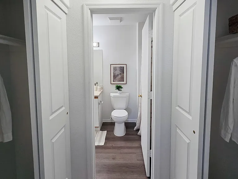 Enjoy the convenience of dual closets leading to a spacious bathroom, creating a private, organized suite designed to simplify your daily routine.