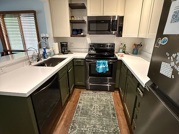 Washable carpet keeps kitchen floor warm in the winter and counter stools are great for a conversation while cooking.