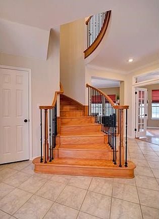 Beautifully curved, hardwood and iron staircase takes you up to the 3 bedrooms, 2 baths and bonus room on the 2nd floor.