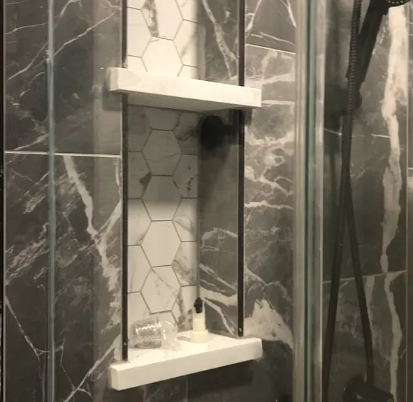 Main shower with double niches - tall / deep enough for shampoo, rain shower and hand held shower heads. Same tile, shower heads in second bath
