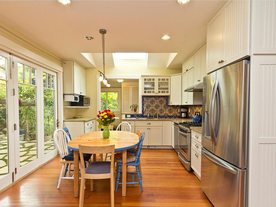 Dining kitchen with previous table set and upper flagstone patio to the right