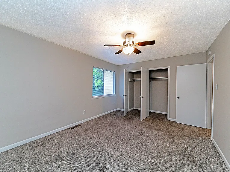 Cozy bedroom with carpet & ceiling fan