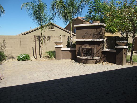 Backyard with Fireplace, Covered Patio and small area for grass.