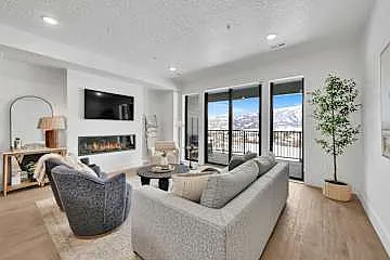 Living room with fireplace, smart TV, and French doors to patio