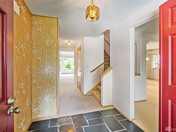 Slate tiled entry, living room to the right hall has main floor bath and closet. 