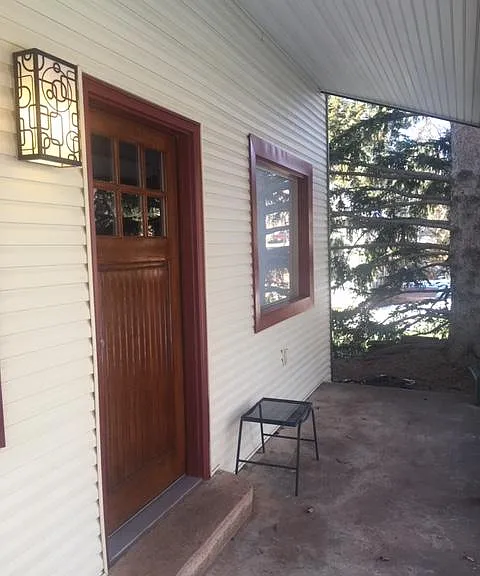 Lovely covered front porch space to enjoy the quiet days of Lyons.
