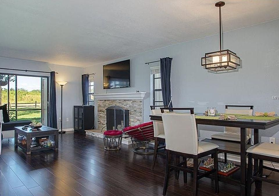 Living, dining room. Very open floor plan with a great view of the back nature area. Dining table and chairs are included.