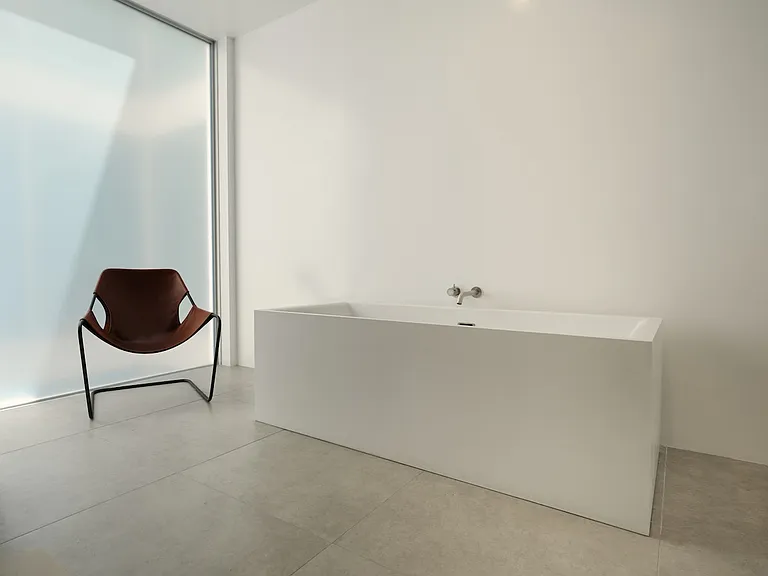 Tranquil Bathroom with Minimalist Elegance _ This primary bathroom features a sleek freestanding tub, floor-to-ceiling glass, and a soothing neutral palette, creating the perfect retreat for relaxation.