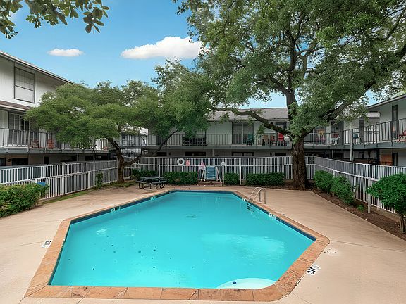 Take advantage of the community pool, surrounded by shade trees and lounge seating. A refreshing spot to relax during your stay.