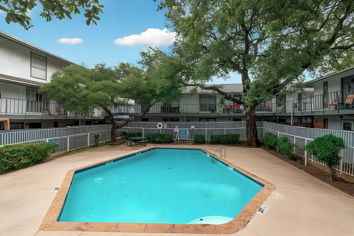 Take advantage of the community pool, surrounded by shade trees and lounge seating. A refreshing spot to relax during your stay. - 12888 Montfort Dr #152