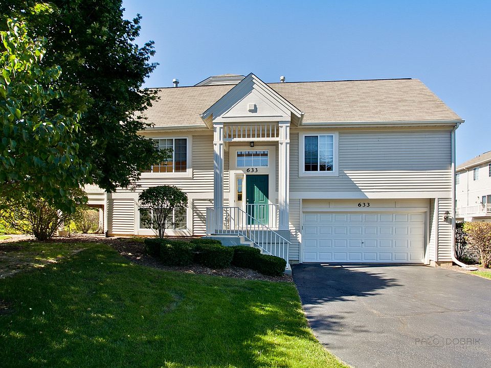 Two car garage with extra parking in driveway.