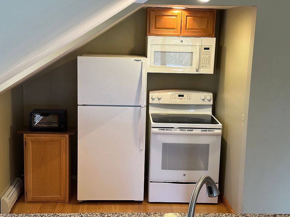 Microwave, range, oven, fridge/freezer. Sink is about 6.5' across from stove/fridge.