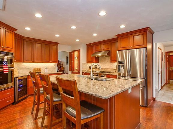 Oversize Island with sink and power seats 3 for informal dining. 