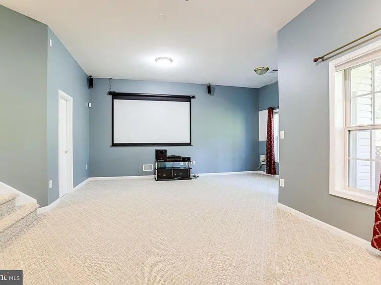 basement - inbuilt media room with projector and reclining screen and curtains for theater effect