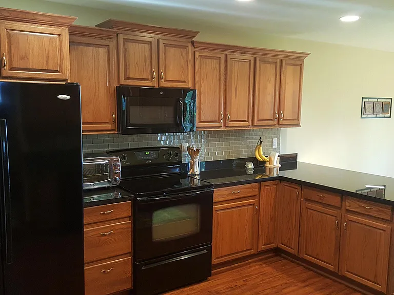 Bright updated kitchen with newer appliances and open dining area.