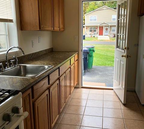 Kitchen from Laundry Room & Back Door into Private Driveway